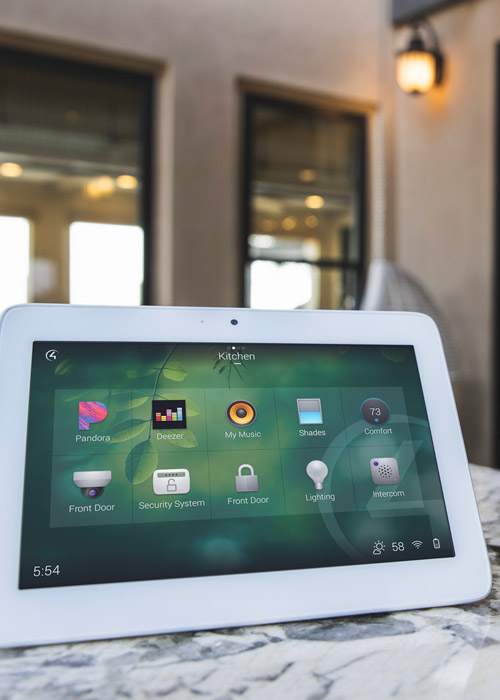 A tablet on a countertop displaying a Control4 home automation interface.