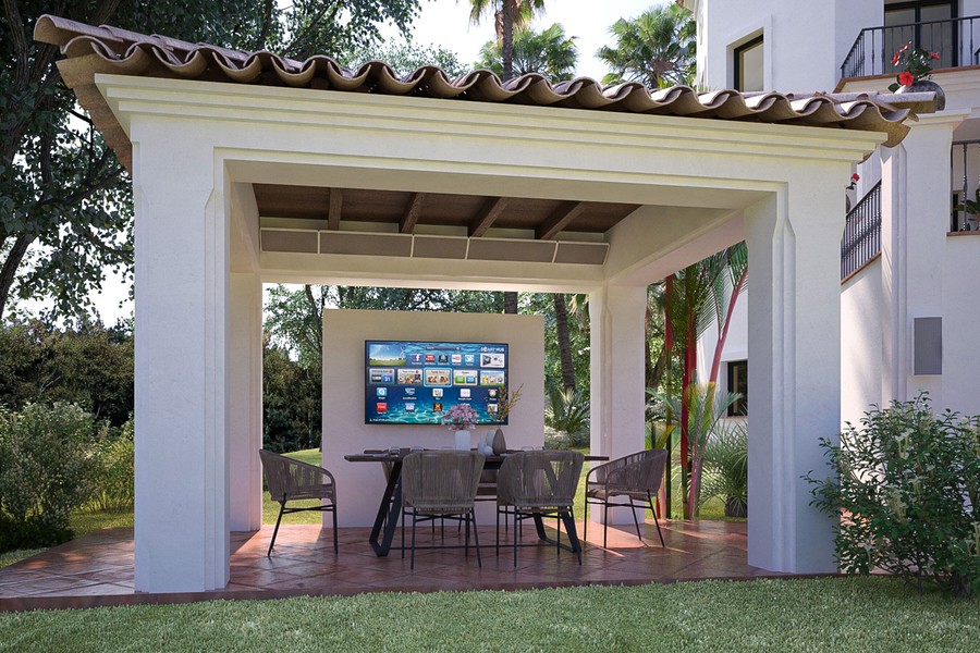 Coastal Source Razor speakers installed under a gazebo area with outdoor seating and TV